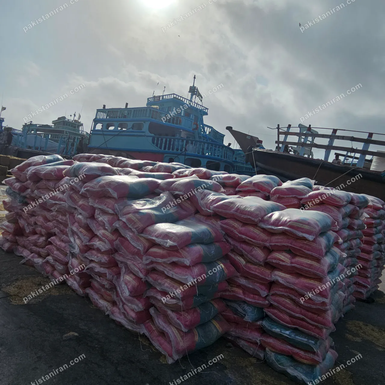 HAS Trading shipment: A full stack of bagged rice on the quay, launches behind