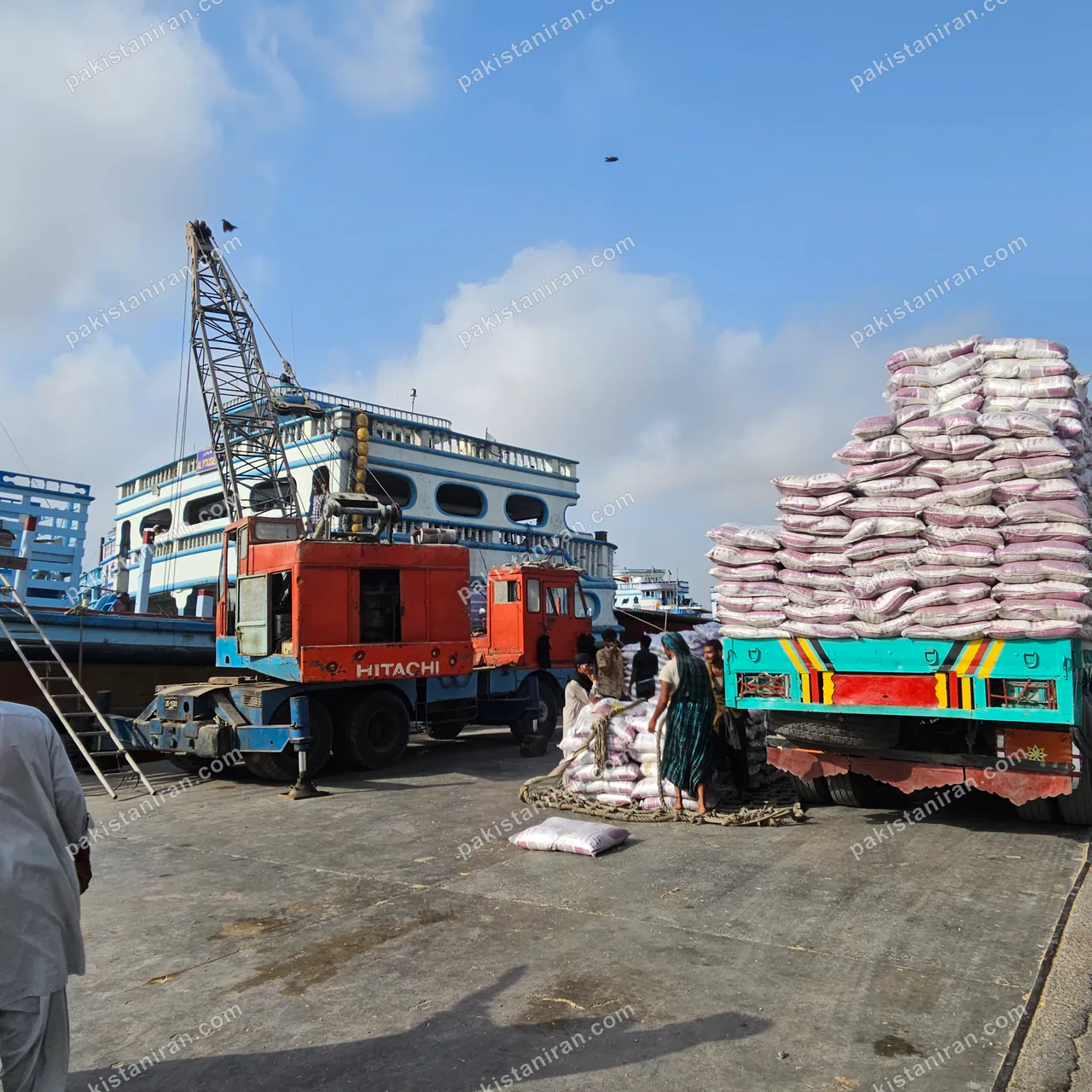 HAS Trading shipment: Rice moved between truck and launch, the crew lashing the load